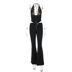 Ensemble composé d'un haut court sans manches à col halter en dentelle florale noire et d'un pantalon long à fermeture éclair pour femmes